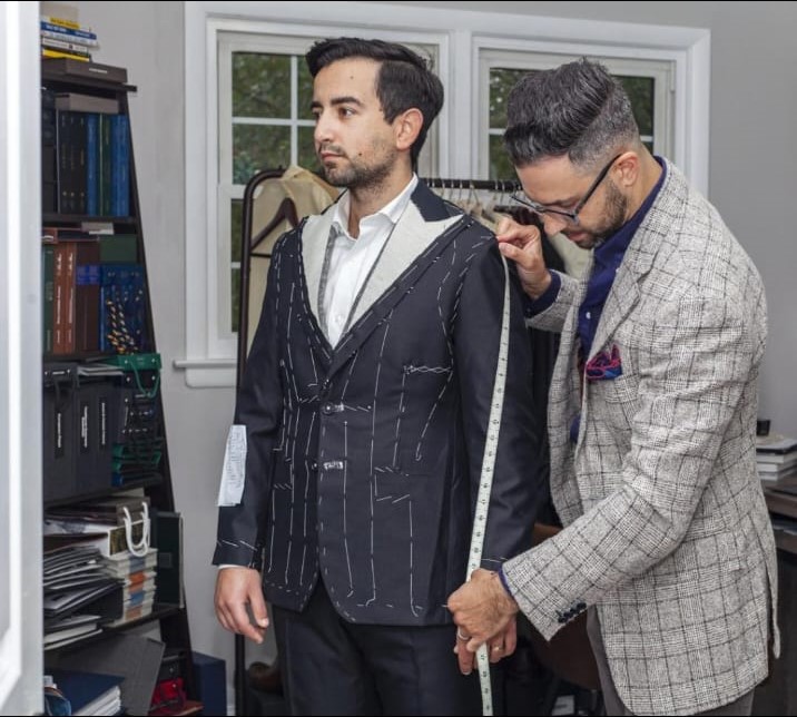 Tailor fitting a men's jacket