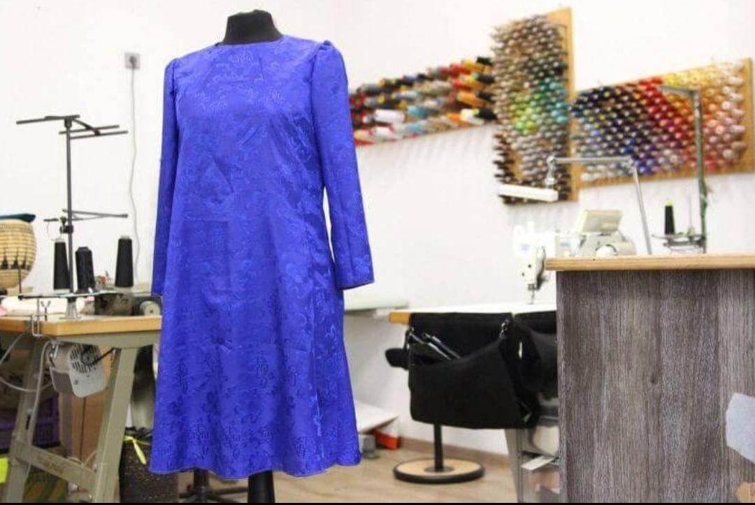Blue tailored dress in studio